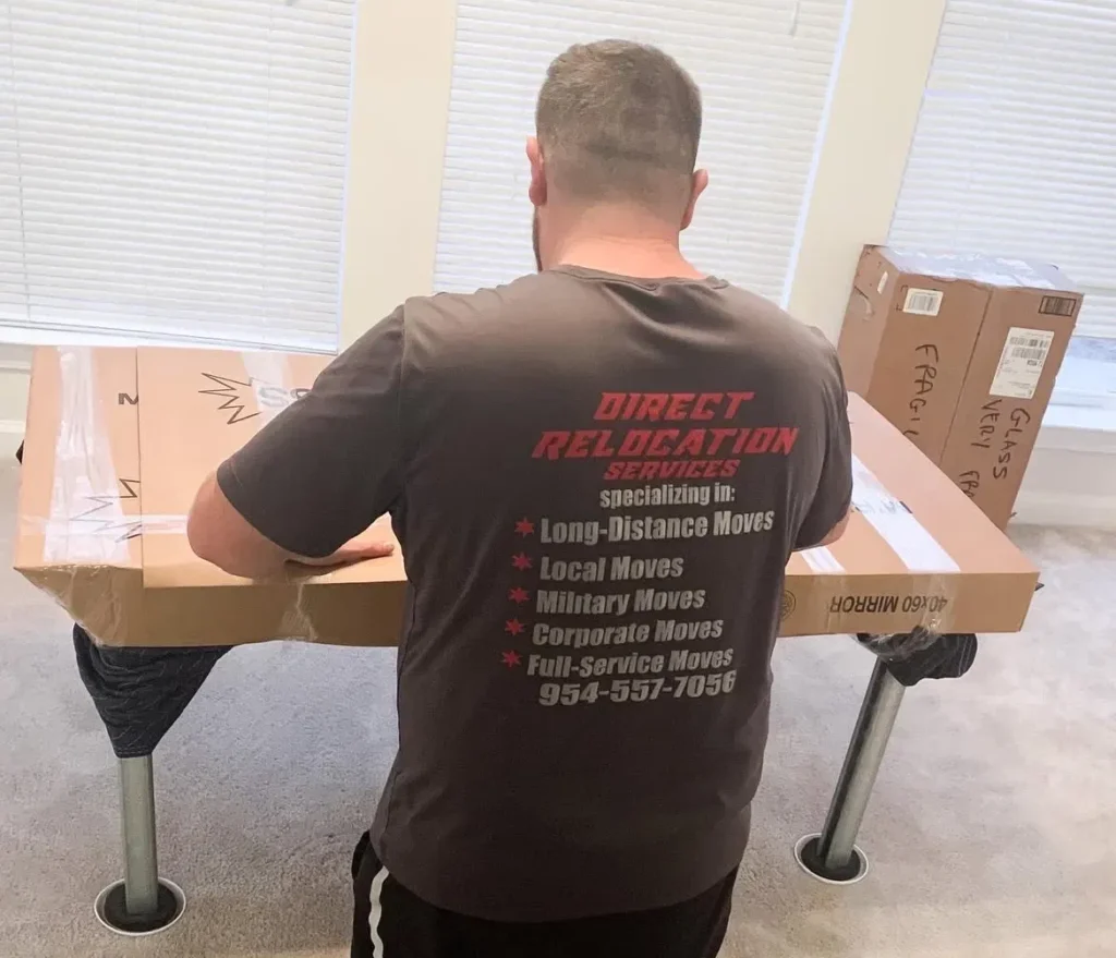Direct Relocation Services mover crating a specialty item in protective cardboard before an interstate move